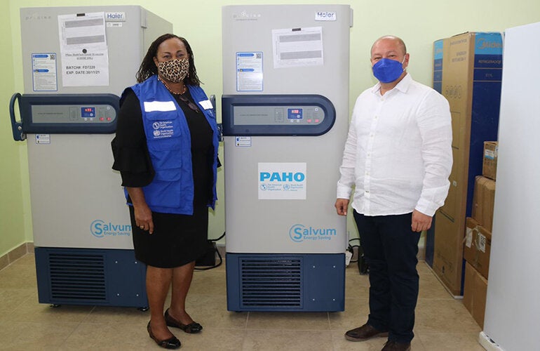 Photo of PWR and Minister of Health flanking the ULT Freezer