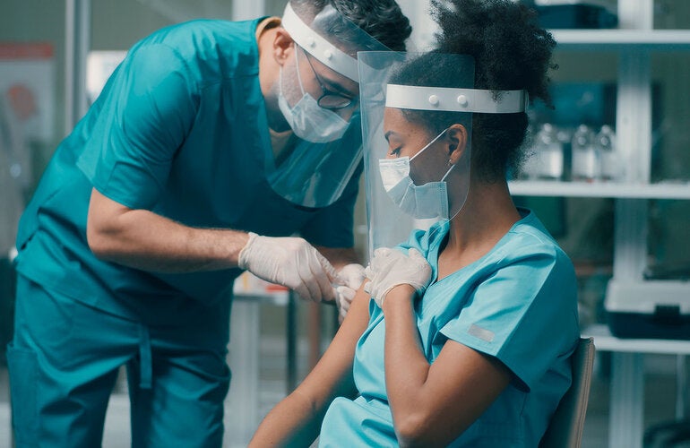 health worker getting vaccinated