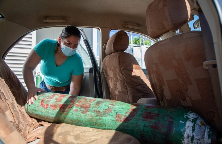 Woman carries oxygen tank in her car