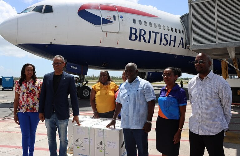 Bahamian Prime Minister Hon. Phillip Davis, Minister of Health and Wellness Dr. Michael Darville, PAHO/WHO BHS Country Representative, Dr. Eldonna Boisson and other government officials receive the first pediatric COVID-19 vaccines. 