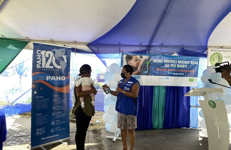 Informative breastfeeding brochure handover by PAHO Representative Dr. Karen Lewis-Bell during the opening of the Breastfeeding Week 2022 in Suriname 