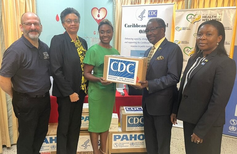 U.S. Ambassador Nick Perry (2nd right) pictured with Hon. Julieth Cuthbert-Flynn, Minister of State, Ministry of Health and Wellness (3rd left) while (L-R) Mr. Ian Stein, Pan American Health Organization/ World Health Organization Representative to Jamaica, Dr. Marlene Tapper, Director of the National Laboratory Services and Dr. Emily Kainne Dokubo, Country Director, U.S. Centres for Disease Control & Prevention look on. 