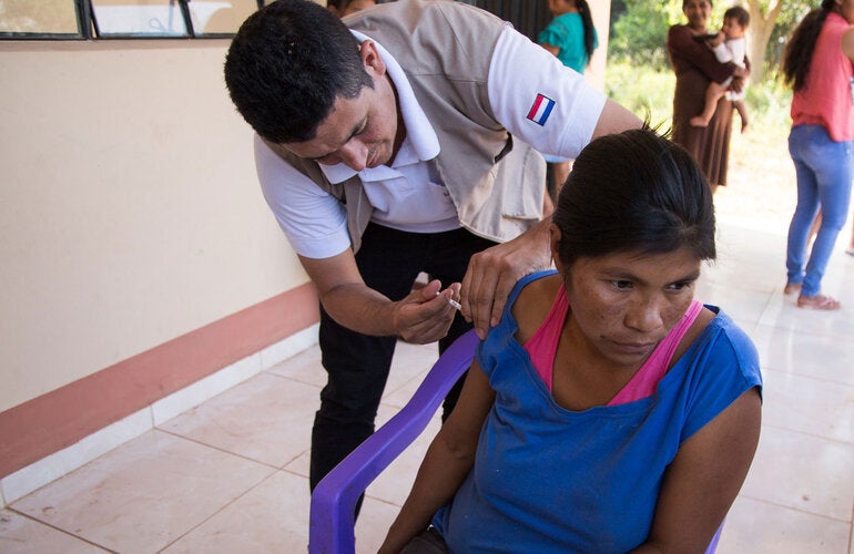 Woman in a remote location receives vaccination
