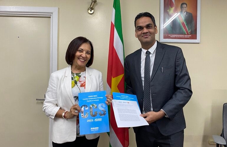 PAHO/WHO Representative Suriname Dr. Lilian Reneau-Vernon & Minister of Health Dr. Amar Ramadhin during the signing