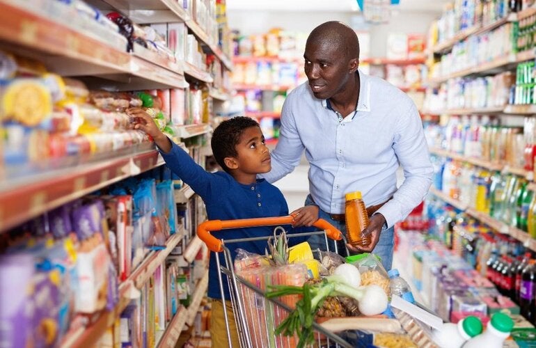 Boy and father selecting products at the supermarket