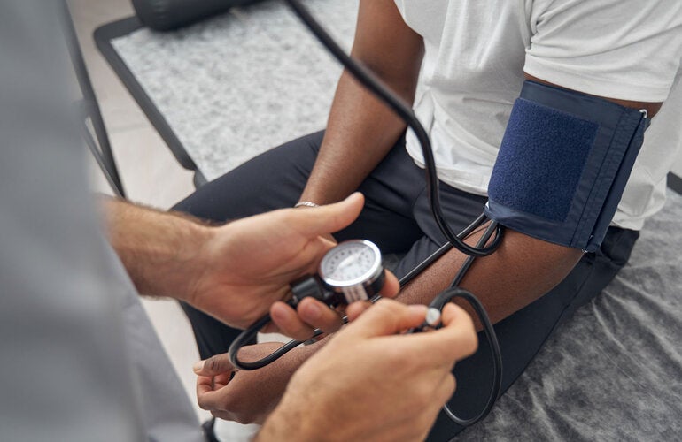 Doctor checks patient's blood pressure