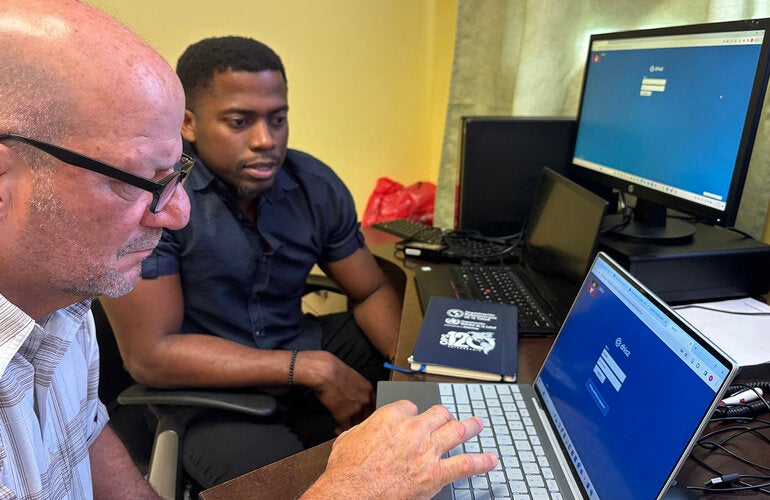Two men looking at computer