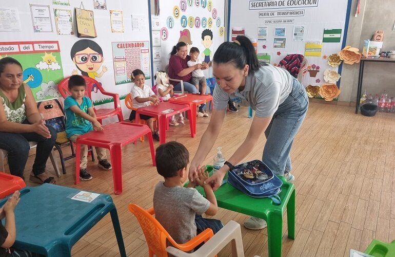 Alejandra Velásquez del proyecto CERF enseña técnica de lavado de manos a niños en Sinuapa, Ocotepeque
