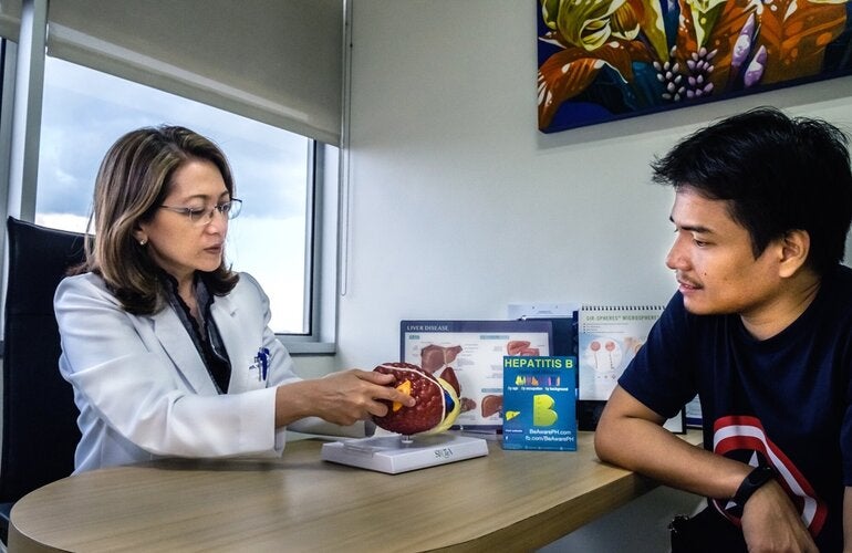 Patient and doctor discuss  liver diseases