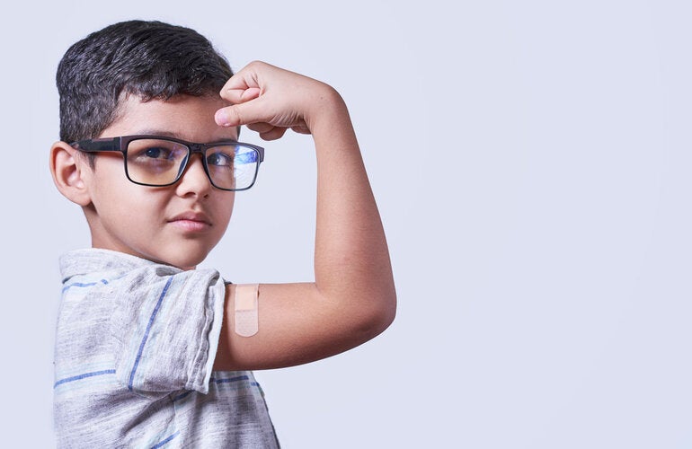 Vaccinated boy shows his arm