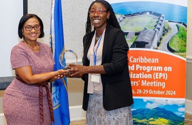 "Jamaica's EPI Manager, Dr Julia Rowe-Porter accepting her award from Chief Medical Officer, Dr Hazel Laws of St Kitts and Nevis"