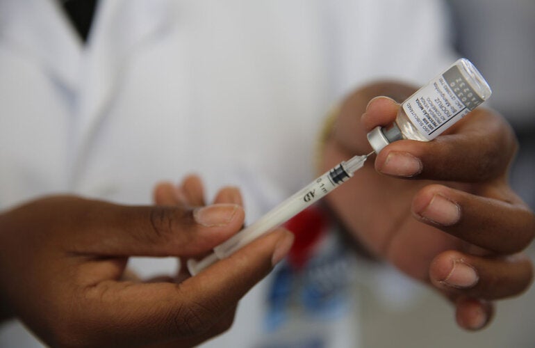 Health worker holds vaccine against yellow fever
