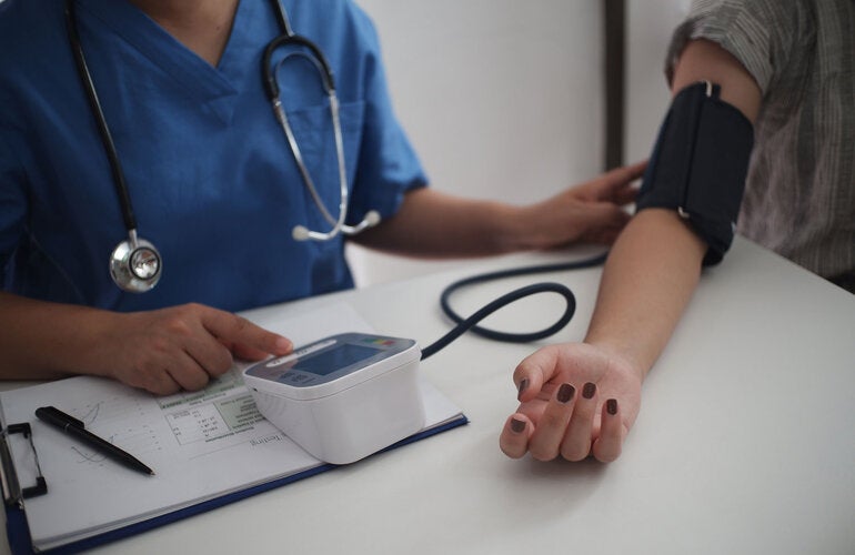 Nurse measuring blood pressure of patient