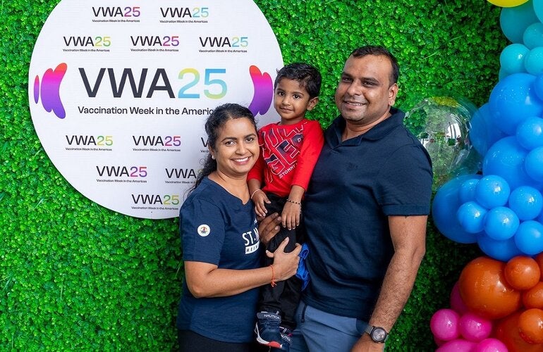 A happy family at the Vaccination and Health Fair for VWA25