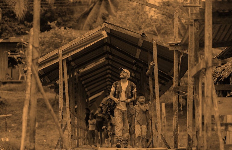 stylized image man and boys on a field trip cross a bridge