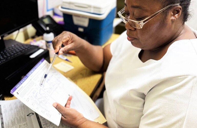 nurse reviews vaccine data