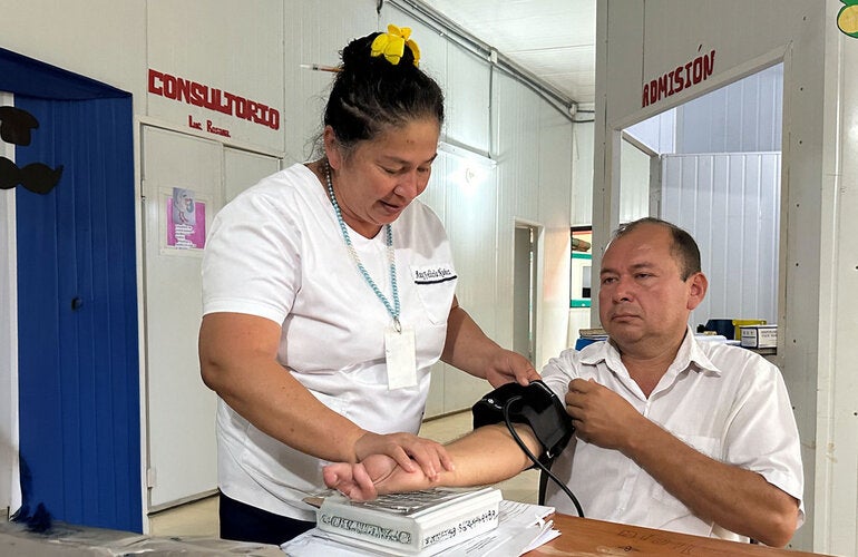 Patient at health centerchecks his blood pressure