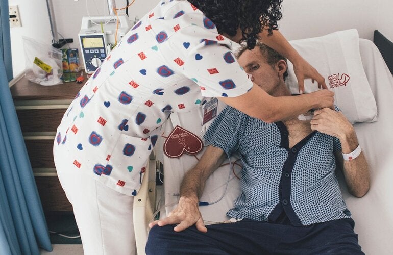 Nurse takes care of patient in hospital setting