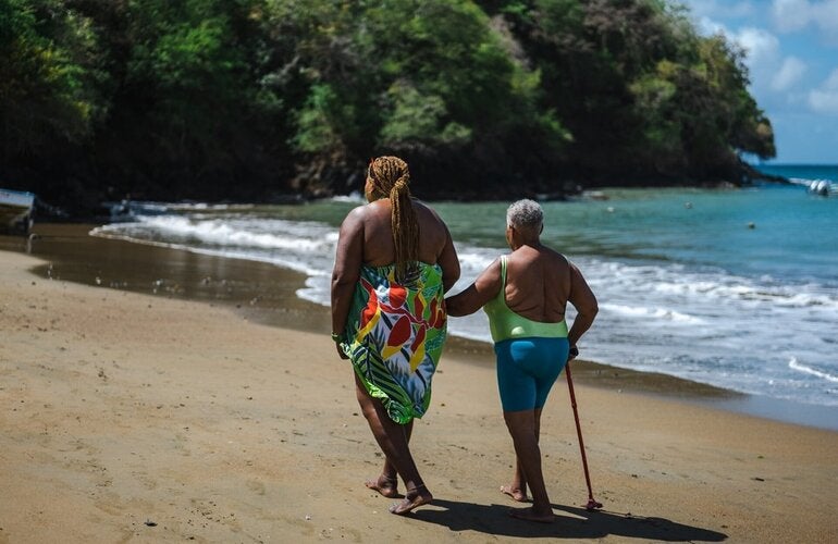 Mother and daughter walk along the beach. exercise.