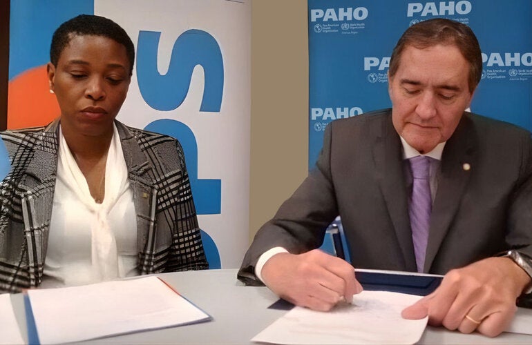 Photo Caption: (L-R) Dr. Rhonda Sealey-Thomas Assistant Director of the Pan American Health Organization witnesses the signing of the Framework Agreement by Dr. Jarbas Barbosa, PAHO Director