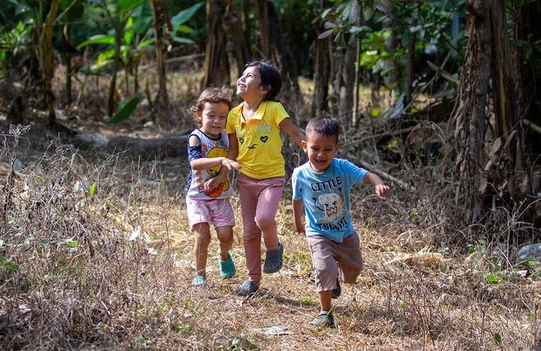 Children running through the fields