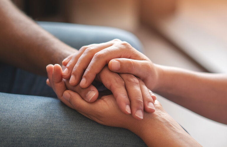Two people holding hands