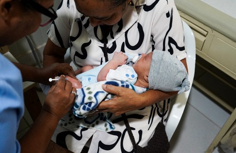 women holding baby