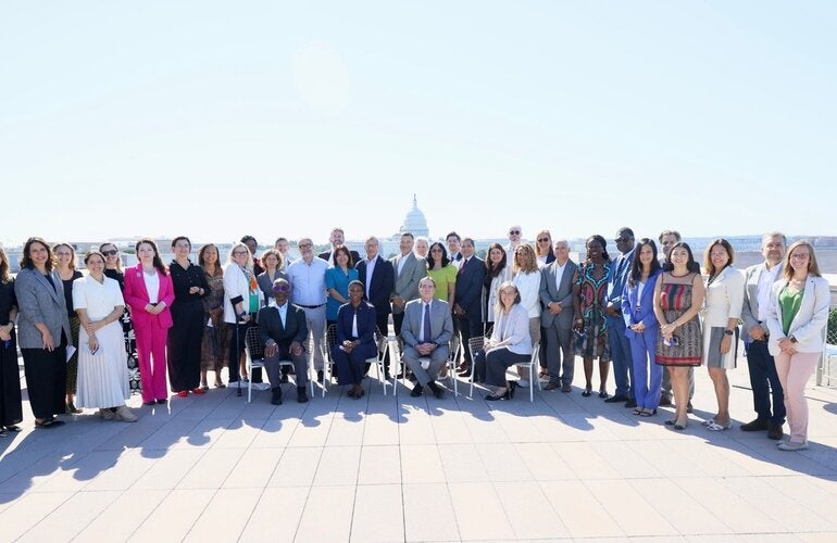 attendees from the meeting standing at a terrace