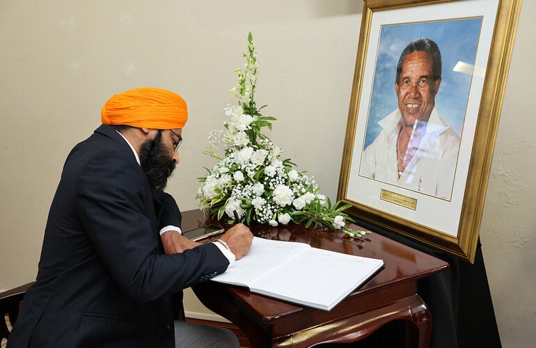 Dr. Prabhjot Singh signs Sir Garfield Sober's condolence book on behalf of PAHO/WHO