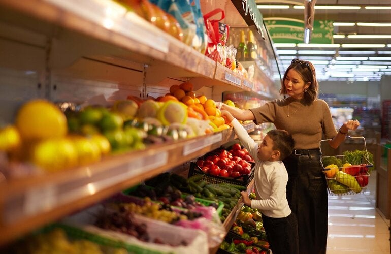 Mother with child shops in a super market