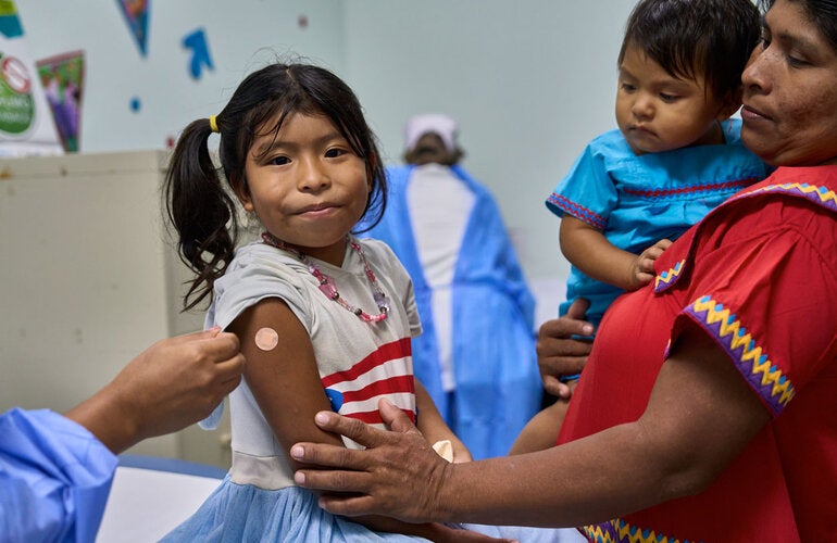 Siblings get vaccinated in las Garzas Health Center in Panama