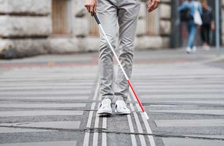 blind man walking on road