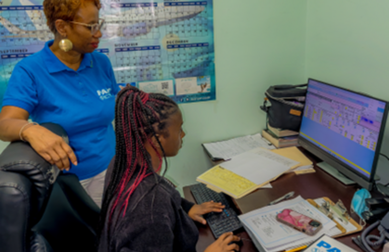 Ms. Sandra Jones, PAHO Advisor for HIV and STIs, observes SIP+ in use by Ms. Marissa Smith, Medical Records Clerk on the Maternity Ward at Rand Memorial Hospital, Grand Bahama.
