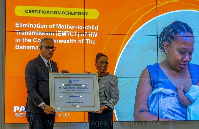 PAHO/WHO Representative presenting the certificate to Dr Michael Darville, Minister of Health and Wellness in the Bahamas