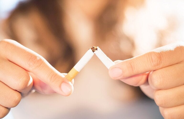 Woman breaking cigarette