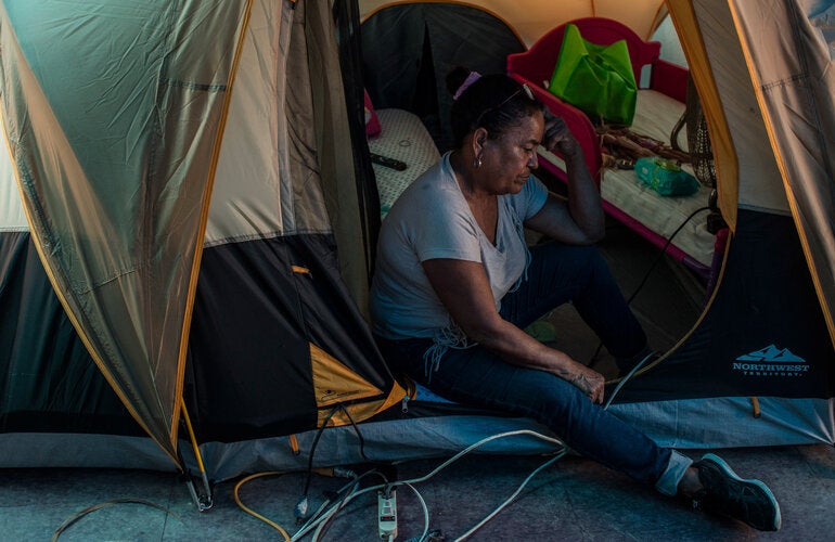 Woman in emergency shelter tent 