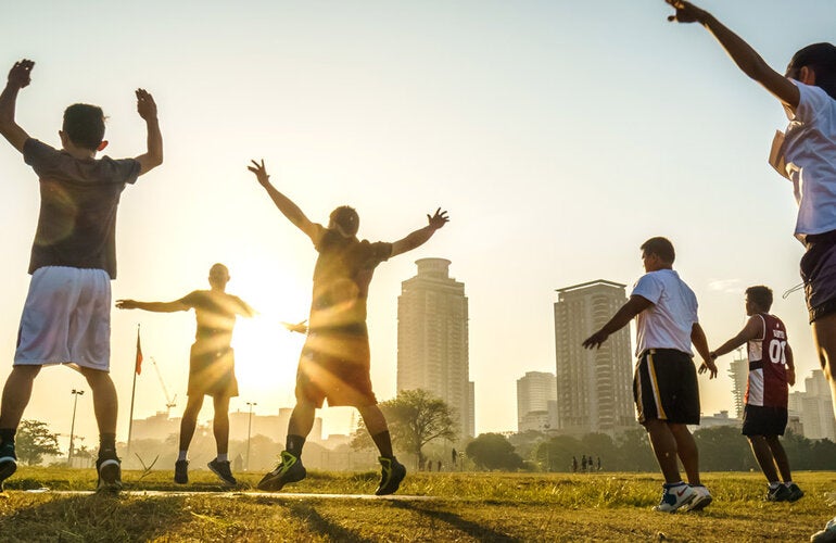 Group of people exercising in open space