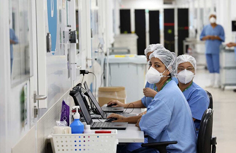 Health personnel with protective gear: mask, gloves, and googles.
