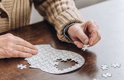 Old adult solving puzzle