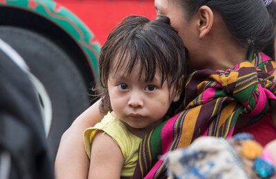 woman carrying child