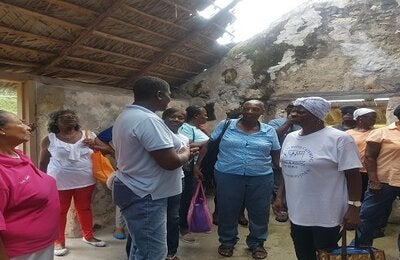 Elderly residents tour a slave ruin during their wellness walk.