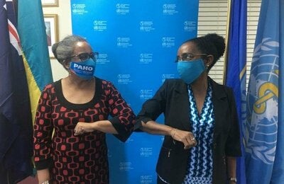 Dr Esther de Gourville, outgoing Country Representative and Dr. Eldonna Boisson, Incoming Country Representative during a friendly conversation.