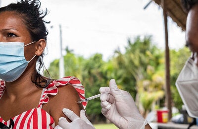 Mujer recibe vacuna contra la COVID-19 en la Amazonia Colombiana