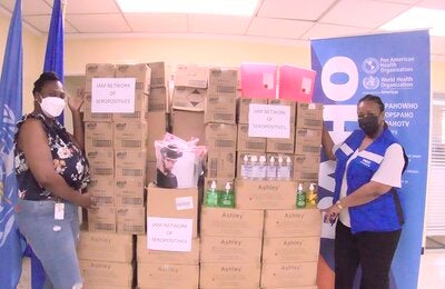 (L-R) Karraine Dillion, Finance Office, Jamaica Network of Seropositives (JN+), pictured in high spirits after receiving personal protective equipment from the Pan American Health Organization (PAHO). Also pictured is Dr. Audrey Morris, Acting Pan American Health Organization/World Health Organization Representative for Jamaica, Bermuda and the Cayman Islands.  