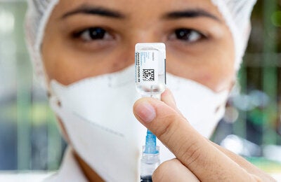 Health worker with COVID-19 vaccine in hand