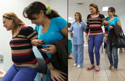 Hunched over: A woman arrives at a health center unable to stand straight and having difficulty walking because of back and joint pain caused by the chikungunya virus. Symptoms of the disease usually appear from three to seven days after a mosquito bite.