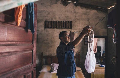 Research vectors: An entomologist installs a trap designed to capture adult mosquitoes in a house. Later, he takes the specimens into his laboratory to study their behavior and patterns of change, such as resistance to insecticides.