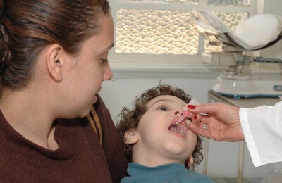 Boy receives oral polio vaccine