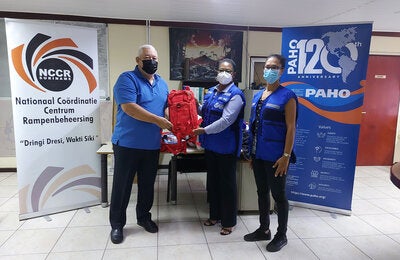 NCCR Coordinator Lt. Col Jerry Slijngard, PAHO Representative Dr. Karen Lewis-Bell, and PAHO National Consultant Astrid van Sauers
