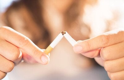 woman breaking cigarette